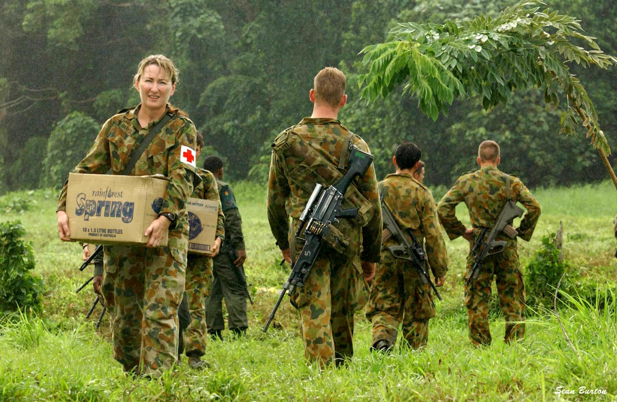 An Australian Army medic carries supplies on a field deployment.